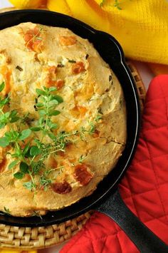 a skillet filled with food sitting on top of a table next to other items