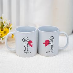 two coffee mugs with stick figures on them