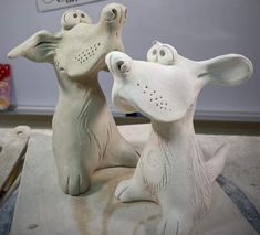 two ceramic dogs sitting next to each other