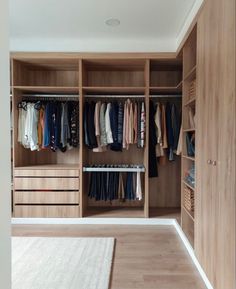 a walk in closet filled with lots of clothes