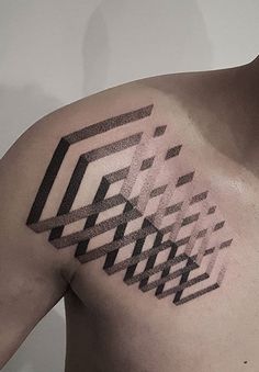 a man's chest with an abstract tattoo design on the left side of his arm