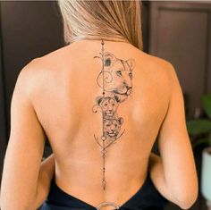 a woman with a tattoo on her back that has a lion and arrow in it