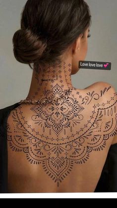 the back of a woman's neck is decorated with intricate designs