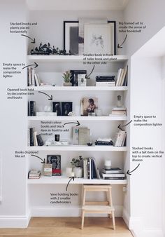 a white bookshelf filled with lots of books and other things on top of it