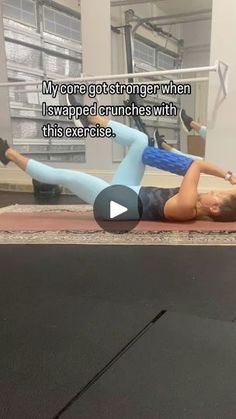 a woman laying on top of a mat in a gym with an exercise quote above her