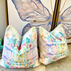 two butterfly pillows sitting on the floor next to each other