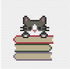 a black and white cat sitting on top of a stack of books cross stitch pattern