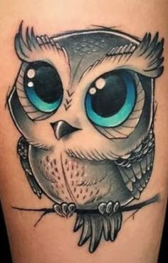 an owl with blue eyes on the thigh