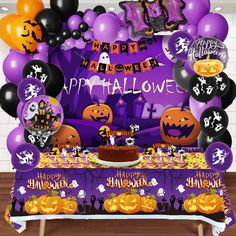 a table topped with balloons and halloween decorations