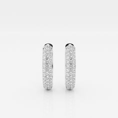 The Bombë Micro Huggie is a luxurious take on an everyday favorite. A miniature version of a classic hoop earring, these 14K gold diamond huggie earrings exude elegance and contemporary style. Three rows of lab grown pave diamonds embellish the curved shape of the earrings, encouraging you to dazzle from every angle. Luxury Dazzling Round Huggie Earrings, Luxury Oval Huggie Earrings For Everyday, White Diamond Huggie Earrings With Pave Setting, Luxury Pave Set Hoop Earrings For Wedding, Luxury Hoop Earrings With Pave Setting For Wedding, Luxury Wedding Hoop Earrings With Pave Setting, Luxury Pave Setting White Gold Huggie Earrings, Luxury White Gold Huggie Earrings With Pave Setting, Everyday Luxury White Gold Hoop Earrings With Pave Setting