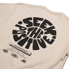 a t - shirt with the words see the sun printed in black on it's back