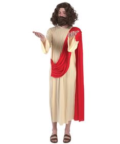 a man dressed as jesus with long hair and beard wearing a red cape, standing in front of a white background