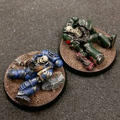 two painted warhammers sitting next to each other