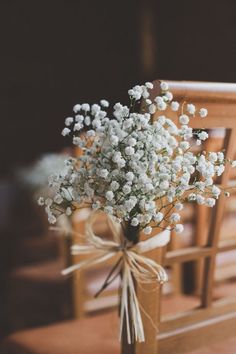 a bouquet of baby's breath sitting on top of a wooden chair