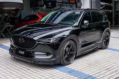 a black mazda cx - 5 parked in a garage