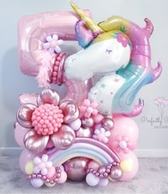 a balloon shaped like a unicorn with flowers and balloons