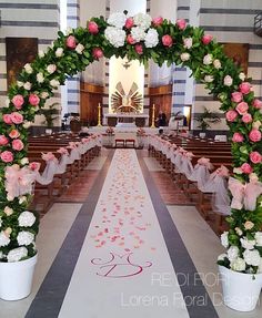 an aisle decorated with pink and white flowers