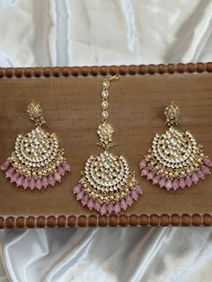 The perfect Chandbali Matching Tikka set for the upcoming season, these are made with the highest quality pachi kundan handwork that are real kundan stones. They come in 4 colors and come as a matching set of maang tikka and chandbali jhumka earrings. A statement piece to wear for weddings, sangeet, reception and mehendi etc events for the bride looking for a gorgeous timeless piece of jewelry to complete her look. It can also make as the perfect gift for any friend or bridesmaid for the festive Punjabi Earrings With Tikka, Luxury Kundan Jhumkas With Latkans, Luxury Kundan Tikka For Reception, Luxury Gold Hoop Earrings With Latkans, Luxury Tikka With Latkans For Festivals, Luxury Jhumkas With Latkans For Navratri, Hand-set Kundan Chandbalis For Festivals, Hand Set Kundan Chandbalis For Festivals, Kundan Chandbali Earrings For Wedding