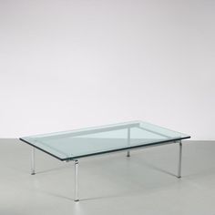 a glass coffee table with metal legs