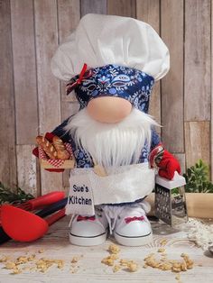 an image of a chef gnome doll on the table with food and utensils