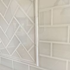 a bathroom with white tiles on the wall