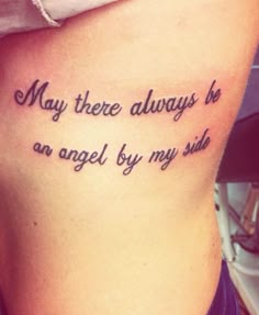 a woman with a tattoo saying, may there always be an angel by my side