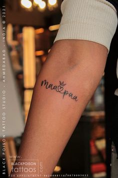 a person with a tattoo on their arm that says maspaa in cursive writing