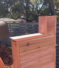 a wooden box sitting in the middle of a yard