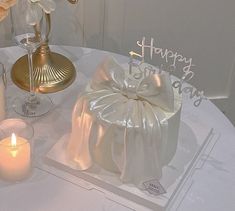 a white table topped with candles and a cake