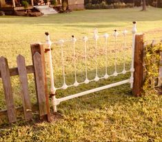 an old wooden fence is in the grass