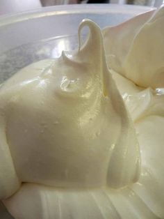 a bowl filled with whipped cream sitting on top of a table