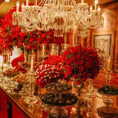 a long table covered in lots of red flowers