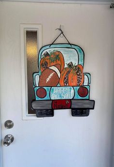 a door hanger with footballs and pumpkins on the back of a truck