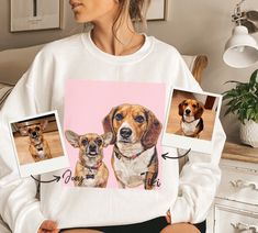 a woman sitting on a bed holding two pictures of dogs