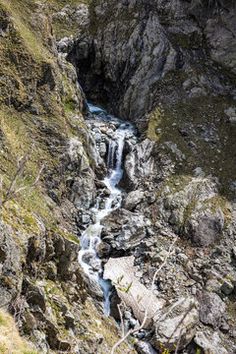 a small waterfall flowing down the side of a mountain