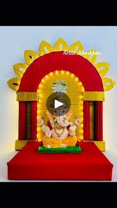 an elephant statue sitting on top of a red and yellow stage