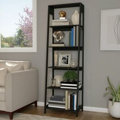 a living room filled with furniture and a book shelf in front of a white couch