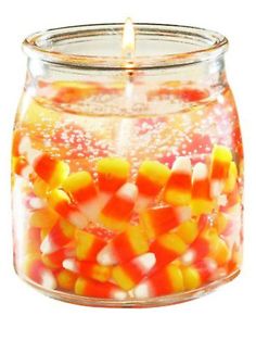 a glass jar filled with candy corn