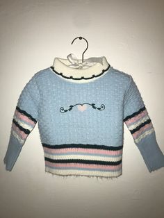 Vintage baby blue turtleneck sweater with a heart design on it.   Brand : Doe Spun Size: 2T Material: Orlon Playful Fitted Winter Sweater, Playful Fitted Sweater For Winter, Cute Blue Long Sleeve Sweater, Cute Blue Winter Top, Playful Fitted Long Sleeve Sweater, Cute Light Blue Long Sleeve Sweater, Cute Blue Winter Sweater, Cute Blue Sweater For Fall, Blue Turtleneck Sweater