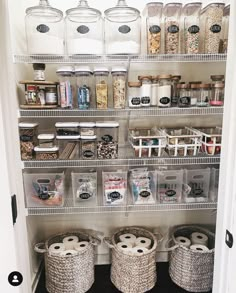 an organized pantry with baskets and jars