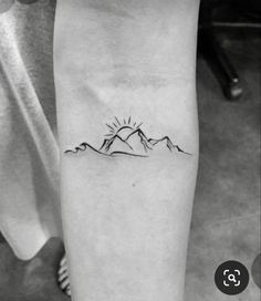 a black and white photo of a mountain tattoo