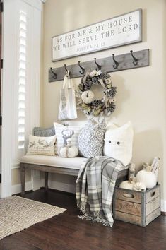 the entryway is decorated with white pumpkins and other fall decorations