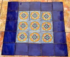 an artistic tile design in blue and orange