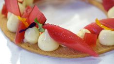 a plate with food on it and garnishes arranged in the shape of flowers