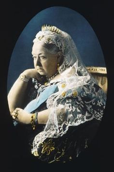 an old photo of a woman wearing a tiara and holding her hands on her chest