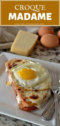 a white plate topped with an egg and cheese sandwich next to eggs on a table