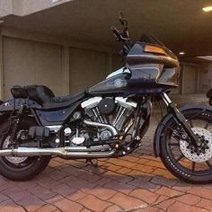 a black motorcycle parked in front of a building