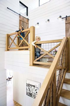 two children are playing on the stairs in their house