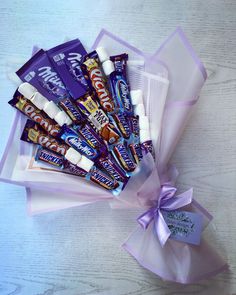 a bunch of candy wrapped in purple ribbon