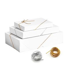 three white boxes with gold wire and two wires